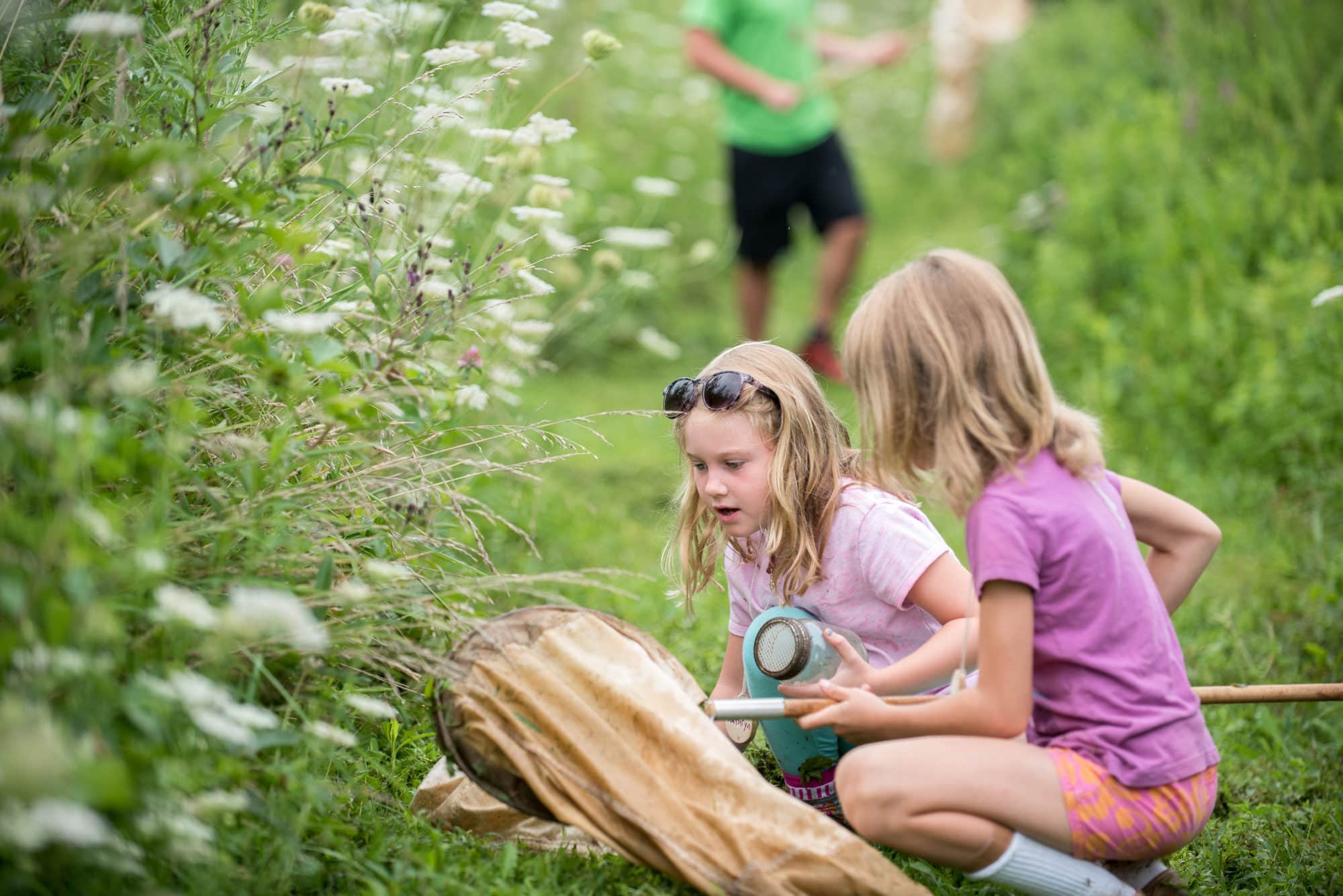 girls looking at butterflies