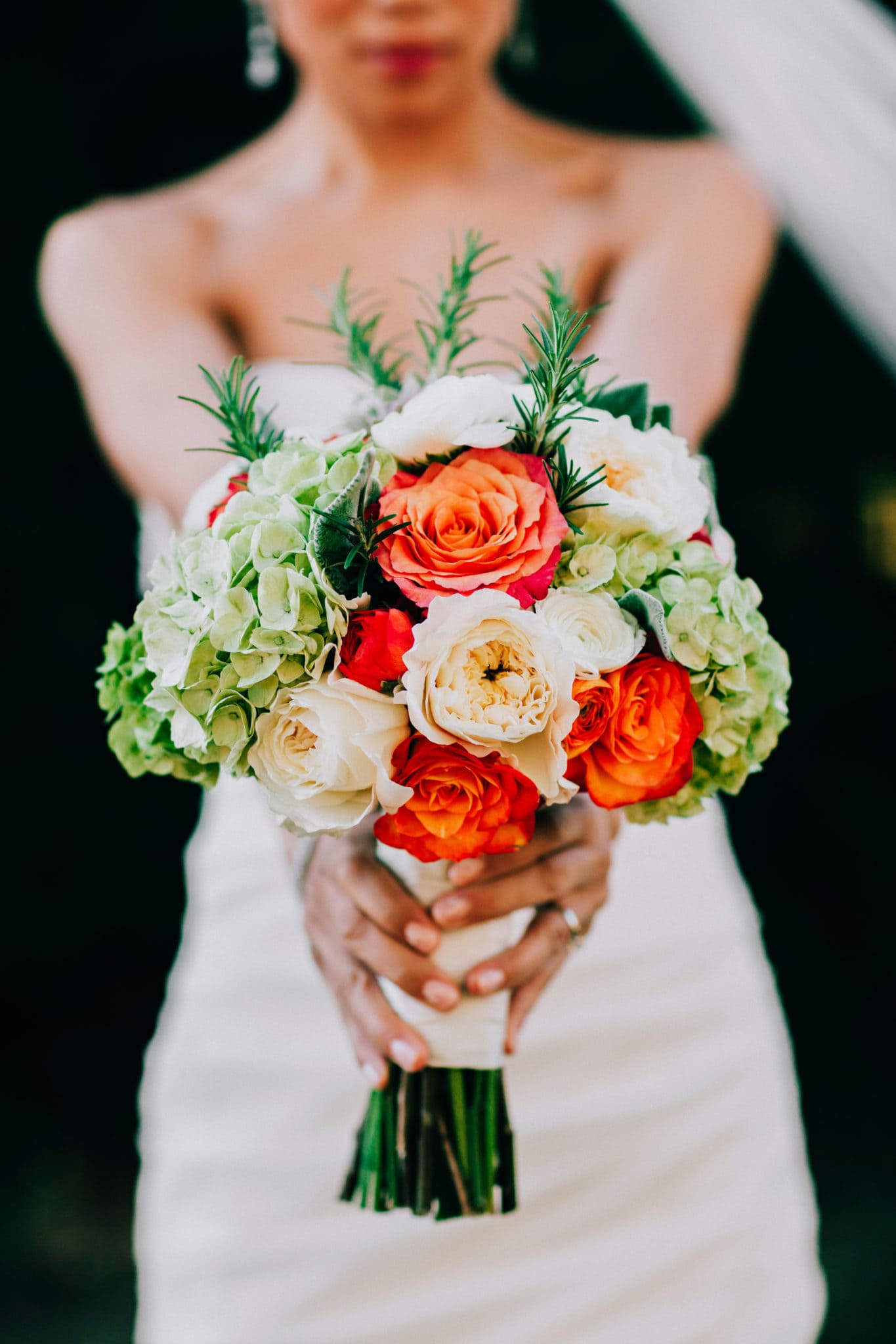 holding out bouquet